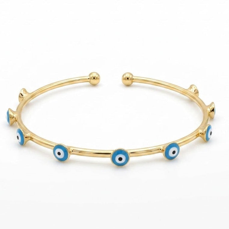 Anti-tarnish yellow gold open cuff bracelet featuring a slender polished band adorned with round bezel-set light blue, white, and black enamel evil eye stations, finished with smooth spherical ball terminals.