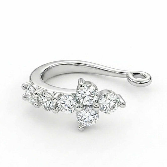 A studio product photograph of a polished silver-toned nose pin featuring a multi-stone cluster design with a central arrangement of round crystal stones and side accents against a clean white background.   