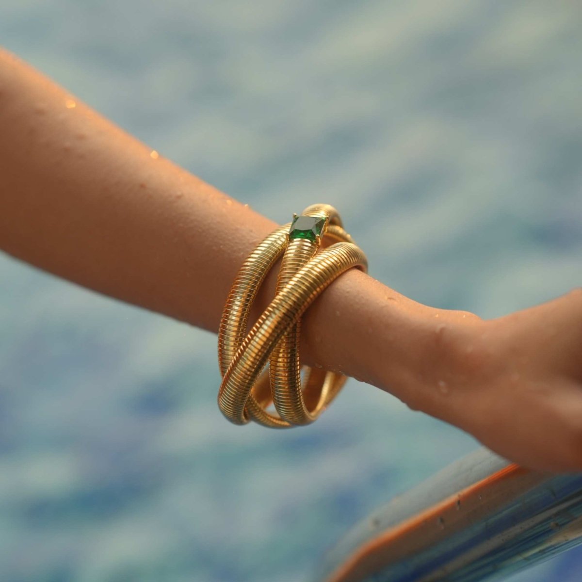 Elegant triple-layer bangles with vibrant emerald stone detailing and an anti-tarnish finish, perfect for party wear, casual elegance, and royal-inspired styling.