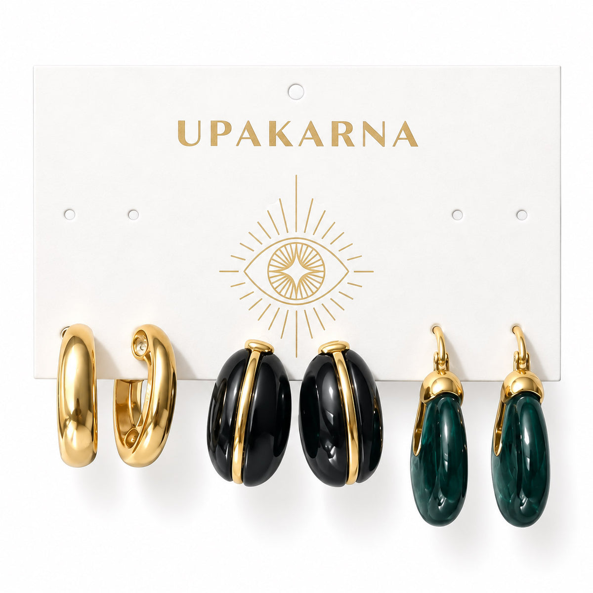 Upakarna earring card featuring chunky gold hoops, glossy black statement hoops, and emerald green drop earrings displayed on a premium white branded card with a minimal luxury aesthetic.