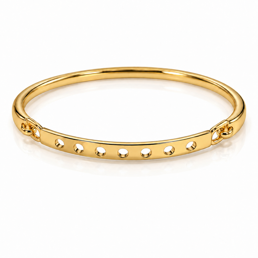 Gold-tone bangle bracelet with a smooth band and six evenly spaced circular cutouts, displayed on a clean white background.