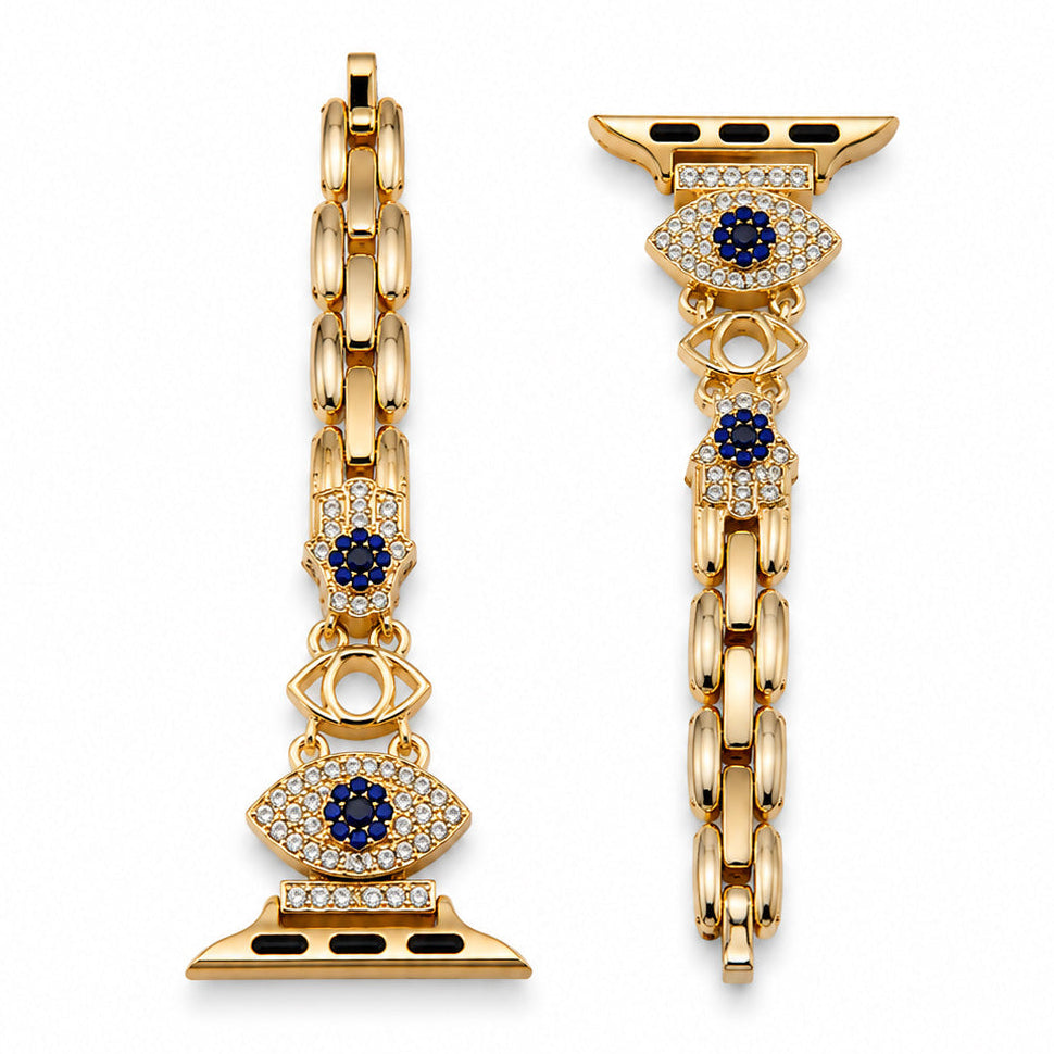 Gold-tone watch belt featuring blue evil eye charms and crystal-studded details on a white background.
