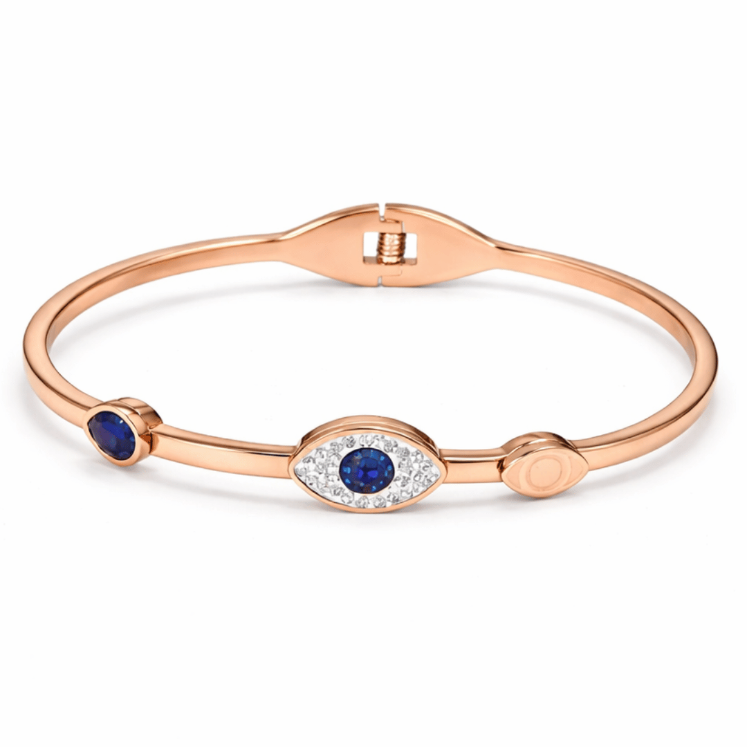 Minimal evil eye bangle with blue enamel and crystal detailing, blending sleek design, protective symbolism, and everyday elegance.