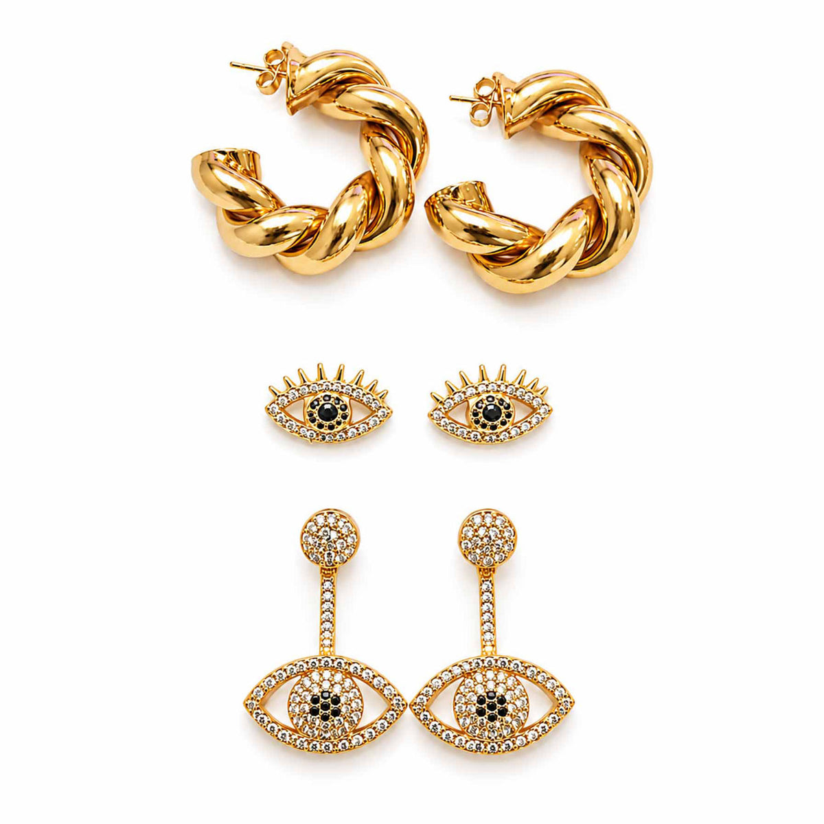 Gold-tone earring stack featuring twisted hoop earrings, crystal evil eye stud earrings, and celestial eye dangler earrings displayed on a clean white background.
