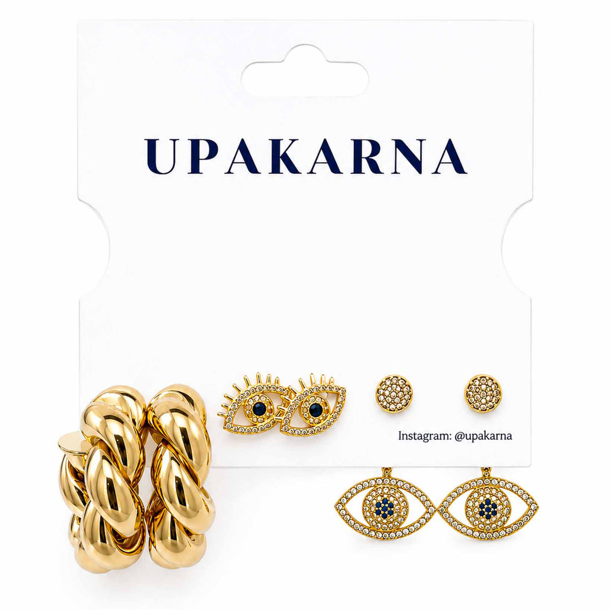 Upakarna gold-tone earring stack featuring twisted hoop earrings, crystal evil eye stud earrings, and celestial eye dangler earrings displayed on a branded white jewellery card.