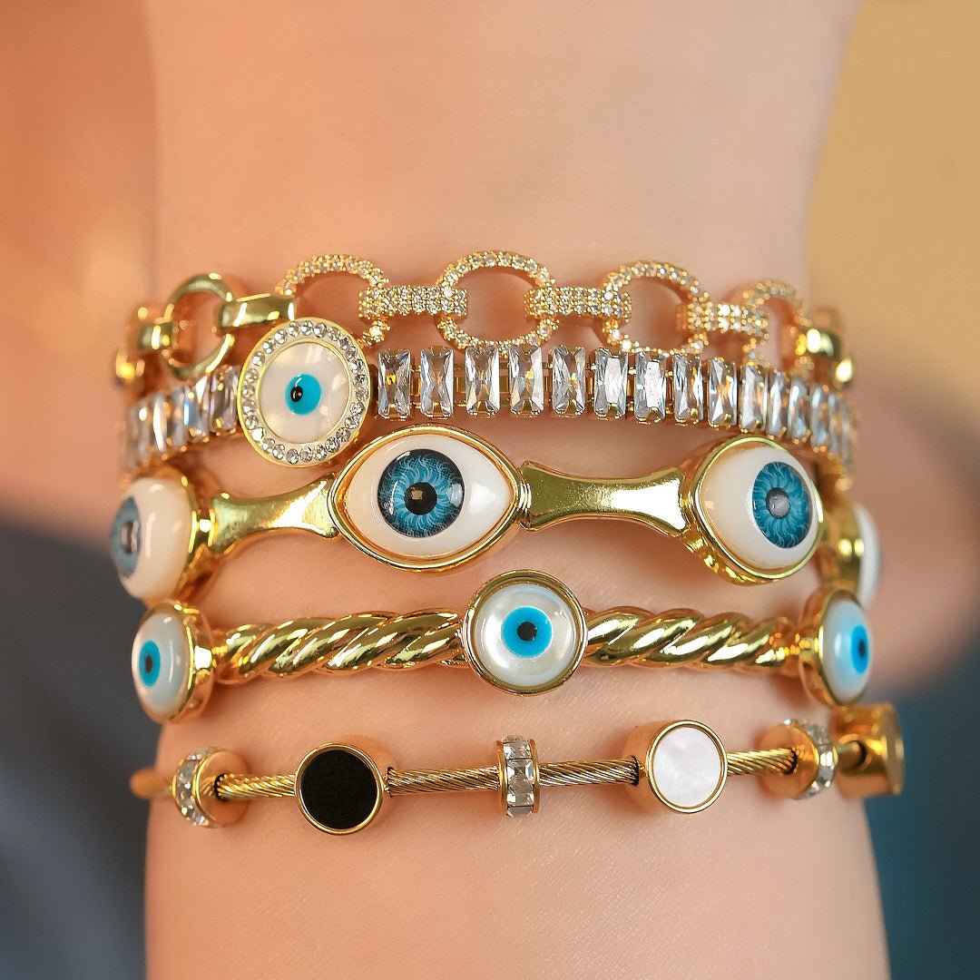 Elegant golden evil eye rope cuff bangle with an adjustable anti-tarnish finish, perfect for trendy everyday styling, chic stacking, and adding a stylish protective touch to any look.