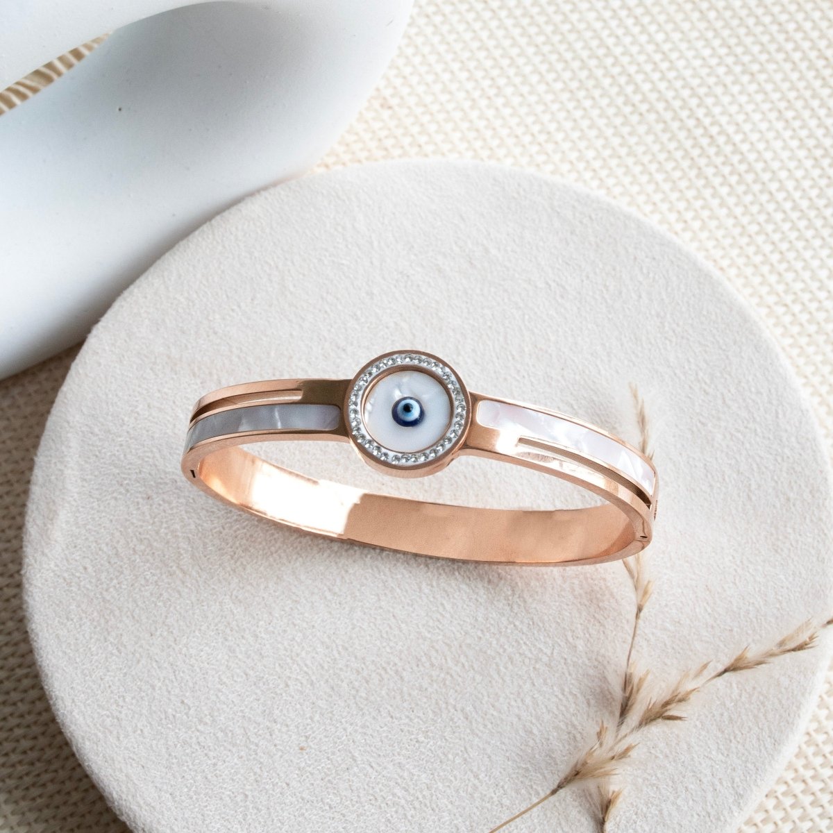 Elegant golden evil eye bangle with intricate detailing and an anti-tarnish finish, perfect for everyday wear, gifting, and adding a chic protective touch to any look.
