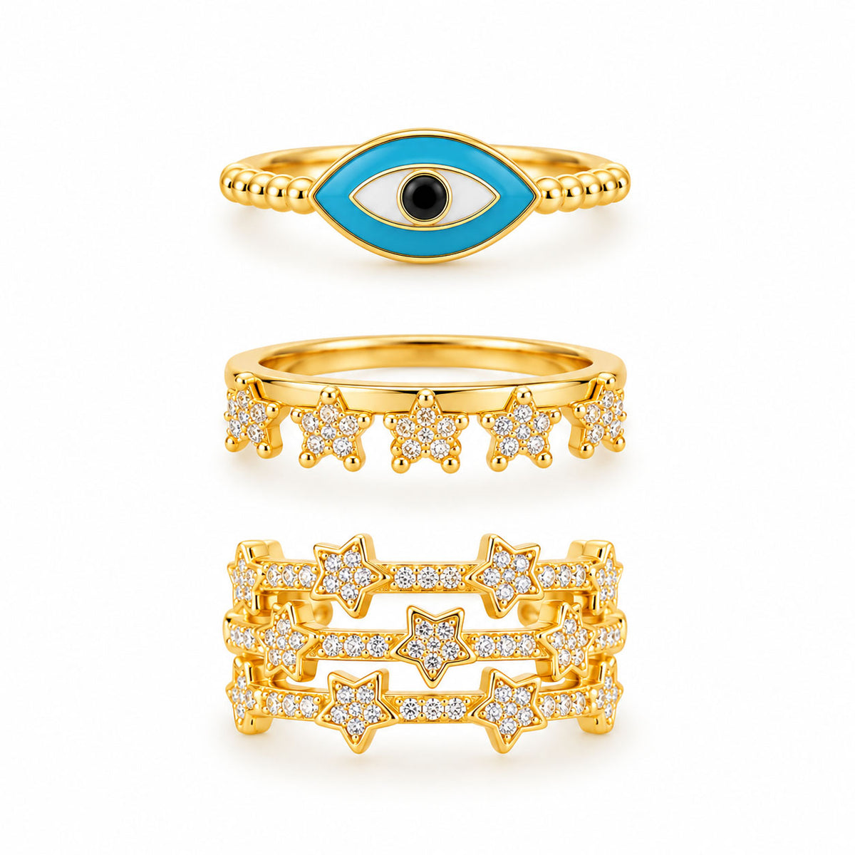 Three gold rings featuring a turquoise evil eye ring, a sparkling star charm ring, and a bold multi-band pavé star ring on a clean white background.
