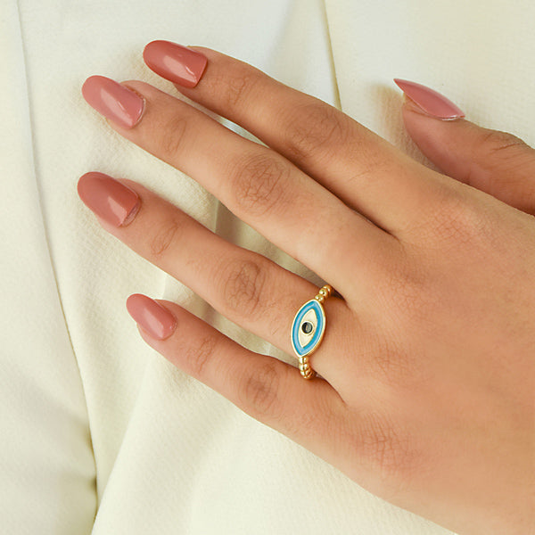 A trio of adjustable gold-toned rings stacked together, featuring a pastel evil eye centerpiece, a sparkling stardust band, and a delicate star-inspired ring.