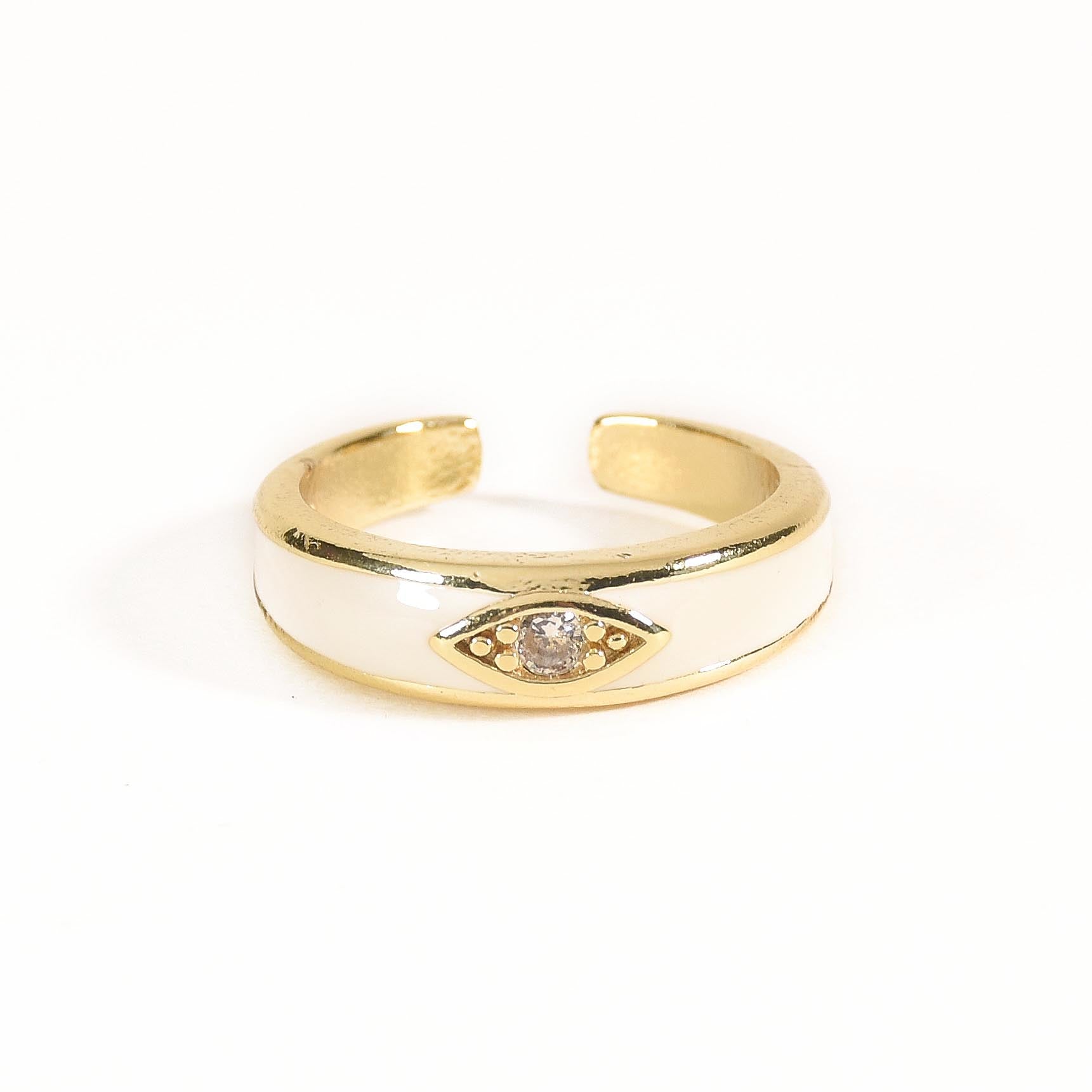 A gold-toned ring stack featuring a blue moonbeam ring, an ivory enamel mystic evil eye, and a crystal-encrusted blink motif.