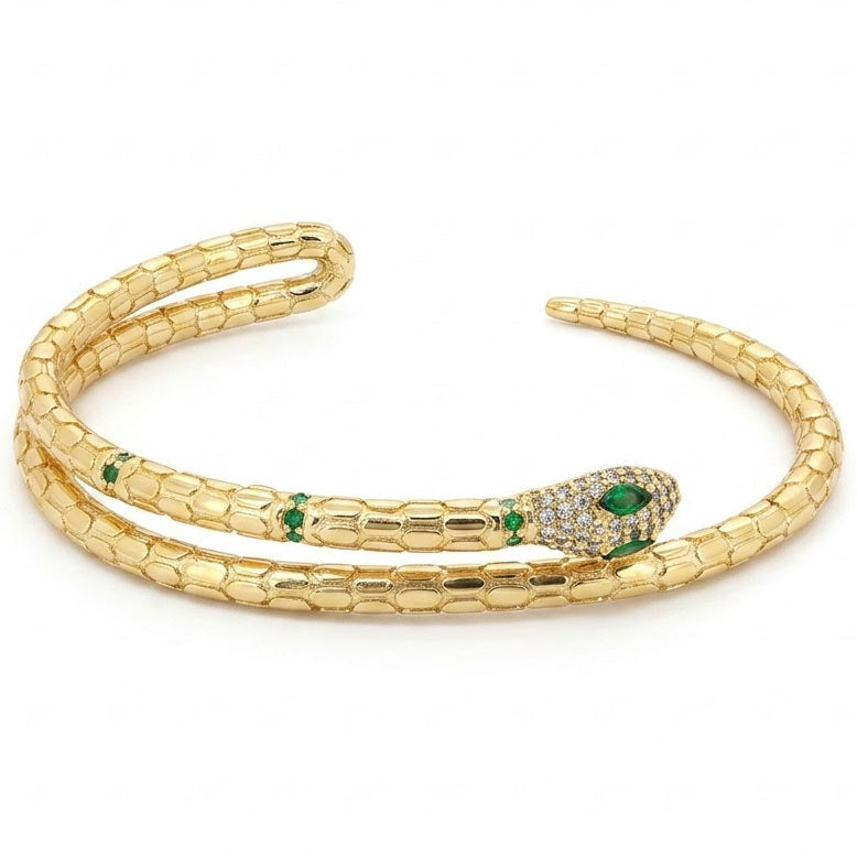 Anti-tarnish gold serpent wrap cuff bracelet featuring a textured python scale body, a pavé cubic zirconia crystal-paved head with marquise green emerald eyes, and green stone accents along the neck.