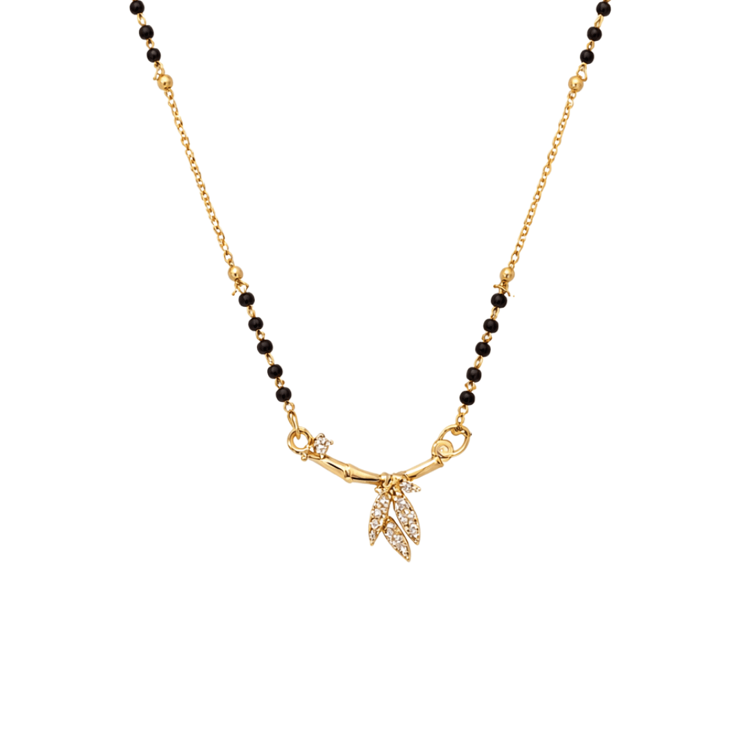 Golden arc mangalsutra necklace with bamboo-inspired bar and pavé leaf pendant in a minimal modern design