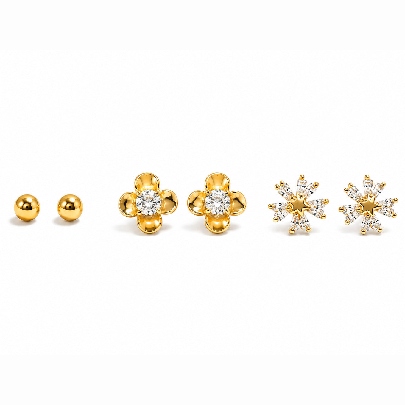 Close-up of a model’s ear styled with a gold floral stud, a sparkling star-shaped stud, and a small gold ball stud.