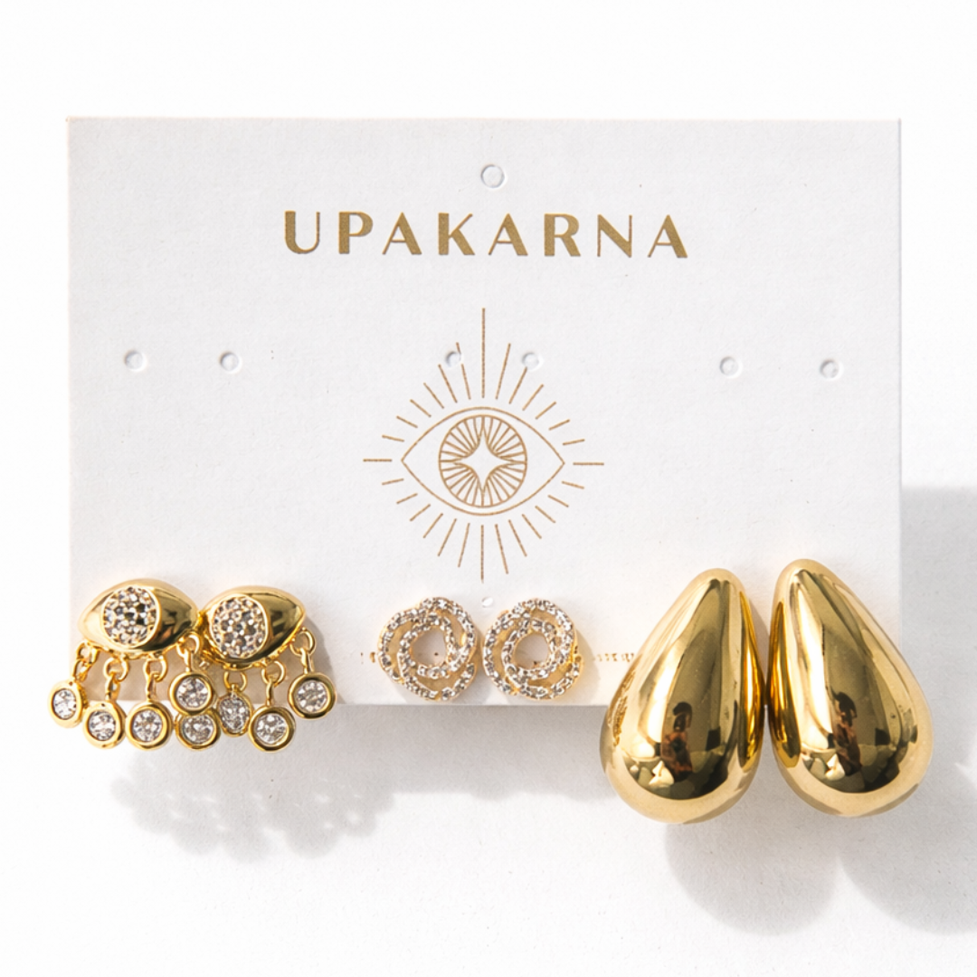 Trendy gold earrings with tear drop shapes, evil eye detail, and minimal stud earrings