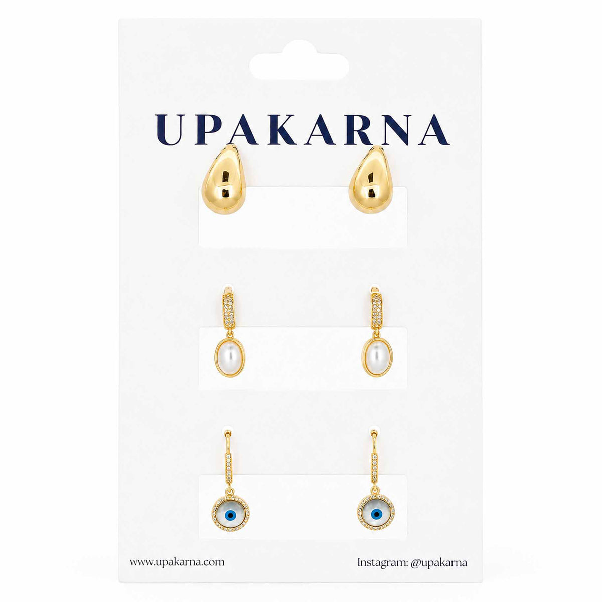 Gold-tone earring stack featuring polished teardrop stud earrings, pearl drop earrings with crystal-studded tops, and circular evil eye dangler earrings on a clean white background.