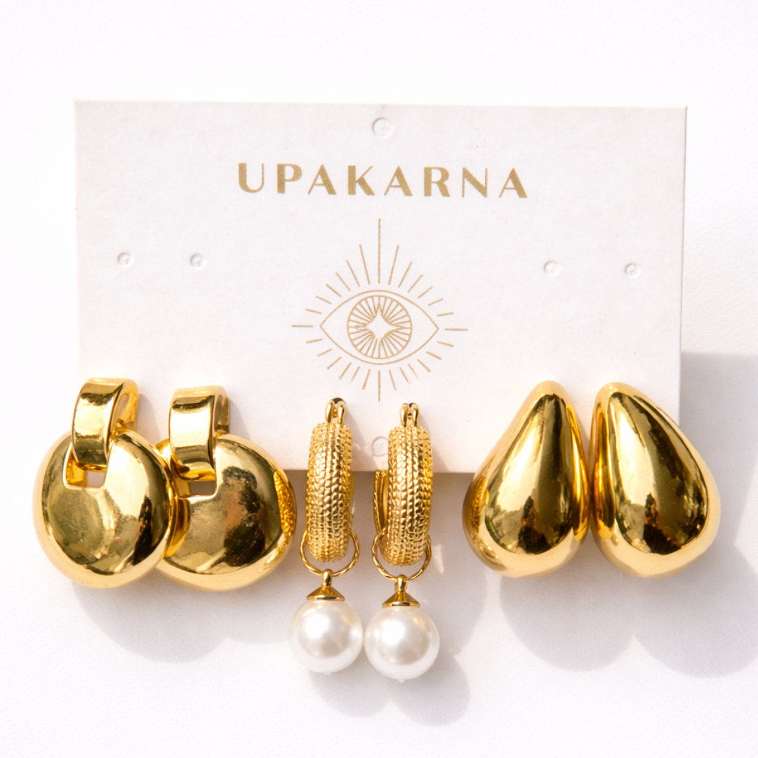 gold earring stack with tear drop earrings, pearl hoop drop earrings, and classic gold disc earrings