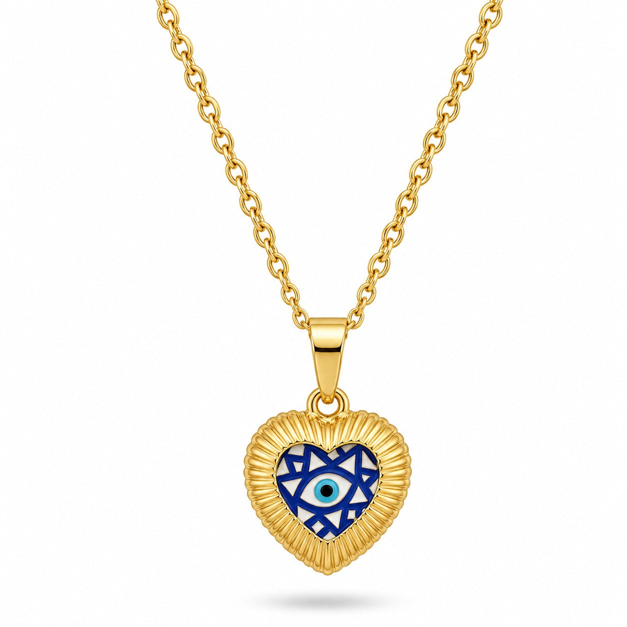 A gold chain necklace holding a heart-shaped pendant with a textured, ribbed gold border. The center of the heart features a dark blue, light blue, and white geometric pattern housing a classic Evil Eye at the core. The piece is displayed against a clean white background with a dark frame.