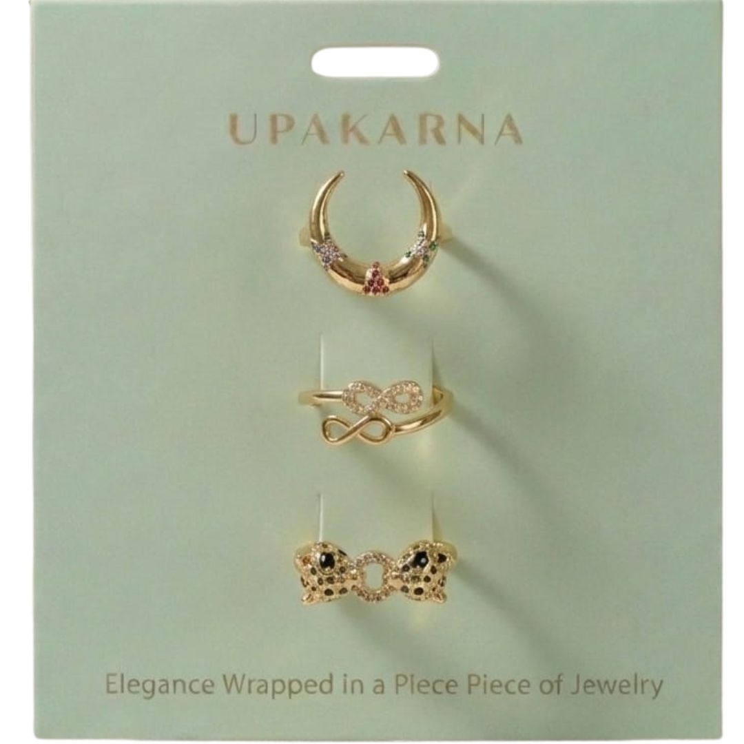 A stacked set of three adjustable gold-toned rings featuring a tiger head motif, a woven infinity band, and a fluid horseshoe-shaped ring.