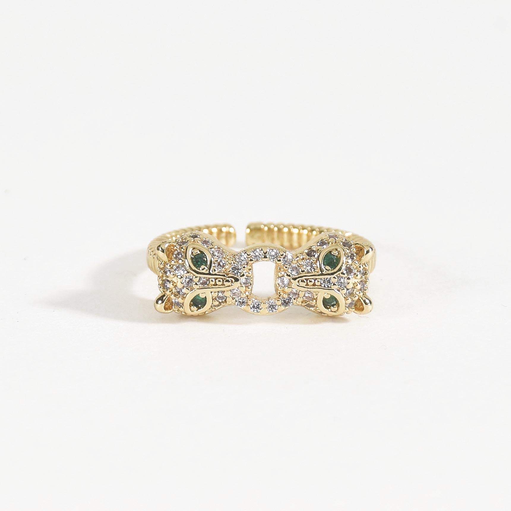 A stacked set of three adjustable gold-toned rings featuring a tiger head motif, a woven infinity band, and a fluid horseshoe-shaped ring.