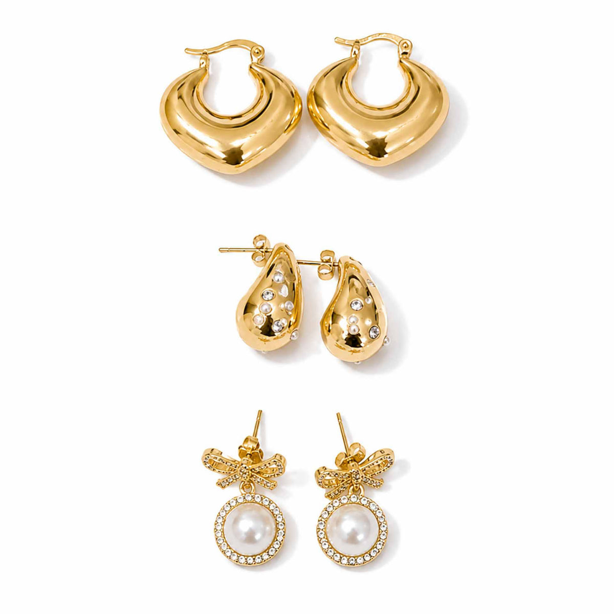 Gold-tone earring stack featuring polished hoops, sparkling embellished teardrop earrings, and pearl bow dangler earrings displayed separately on a clean white background.