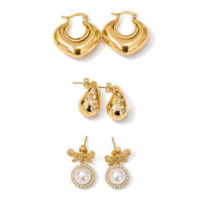 Gold-tone earring stack featuring polished hoops, sparkling embellished teardrop earrings, and pearl bow dangler earrings displayed separately on a clean white background.