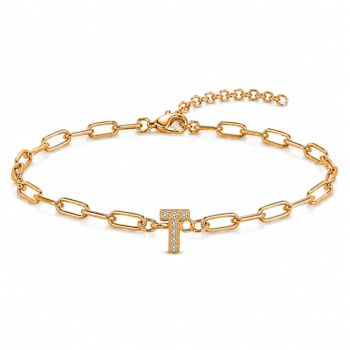 Gold-tone chain bracelet with elongated oval links, a sparkling letter “T” charm, lobster clasp, and adjustable extender chain, displayed on a clean white background.