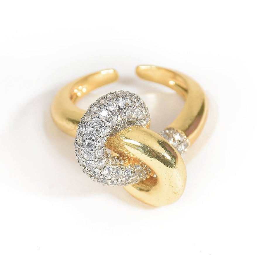 Elegant golden intertwined knot ring with sparkling pavé detailing and an anti-tarnish finish, perfect for everyday sophistication, romantic styling, and versatile wear.

