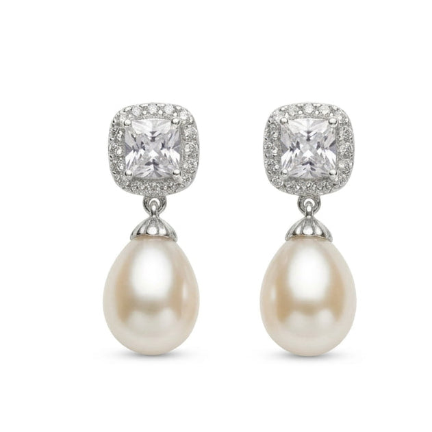 Silver pearl drop earrings with square-cut crystal studs and teardrop pearls, displayed on a white background
