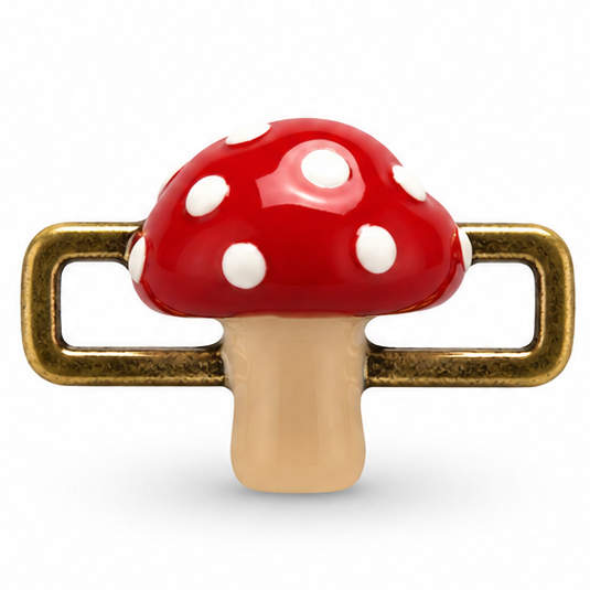 Detailed red and gold mushroom jewellery charm featuring a glossy red mushroom cap covered with multiple white circular spots, a smooth beige stem, and textured antique-gold rectangular loops extending horizontally from both sides.