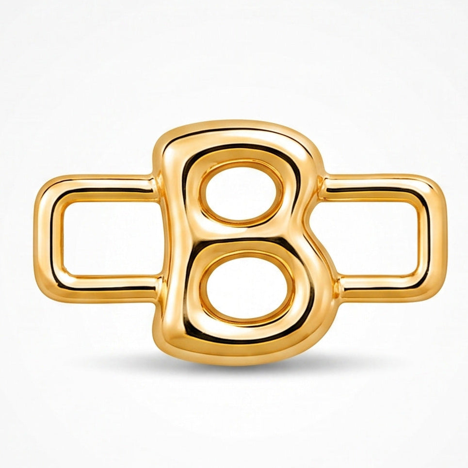 A polished gold-tone letter “B” charm with a glossy, reflective finish, featuring a bold uppercase A design integrated with a rectangular open-link frame. The charm has smooth rounded edges, a modern minimalist style, and a bright metallic surface, displayed against a clean white background.