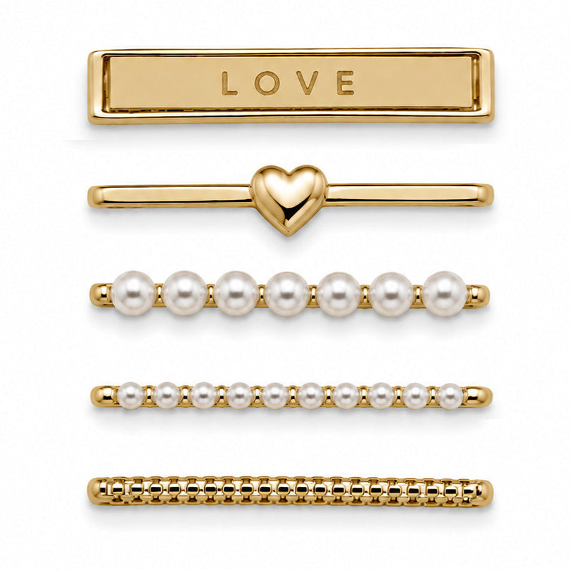 Gold-tone watch charms featuring a LOVE bar, heart detail, pearl accents, and textured chain-style designs, displayed on a white background.