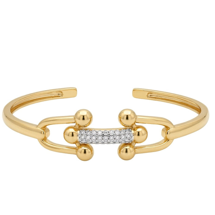 Anti-tarnish gold open cuff bracelet featuring two interlocking U-shaped links with polished ball accents, joined by a central bar encrusted with sparkling pavé cubic zirconia.