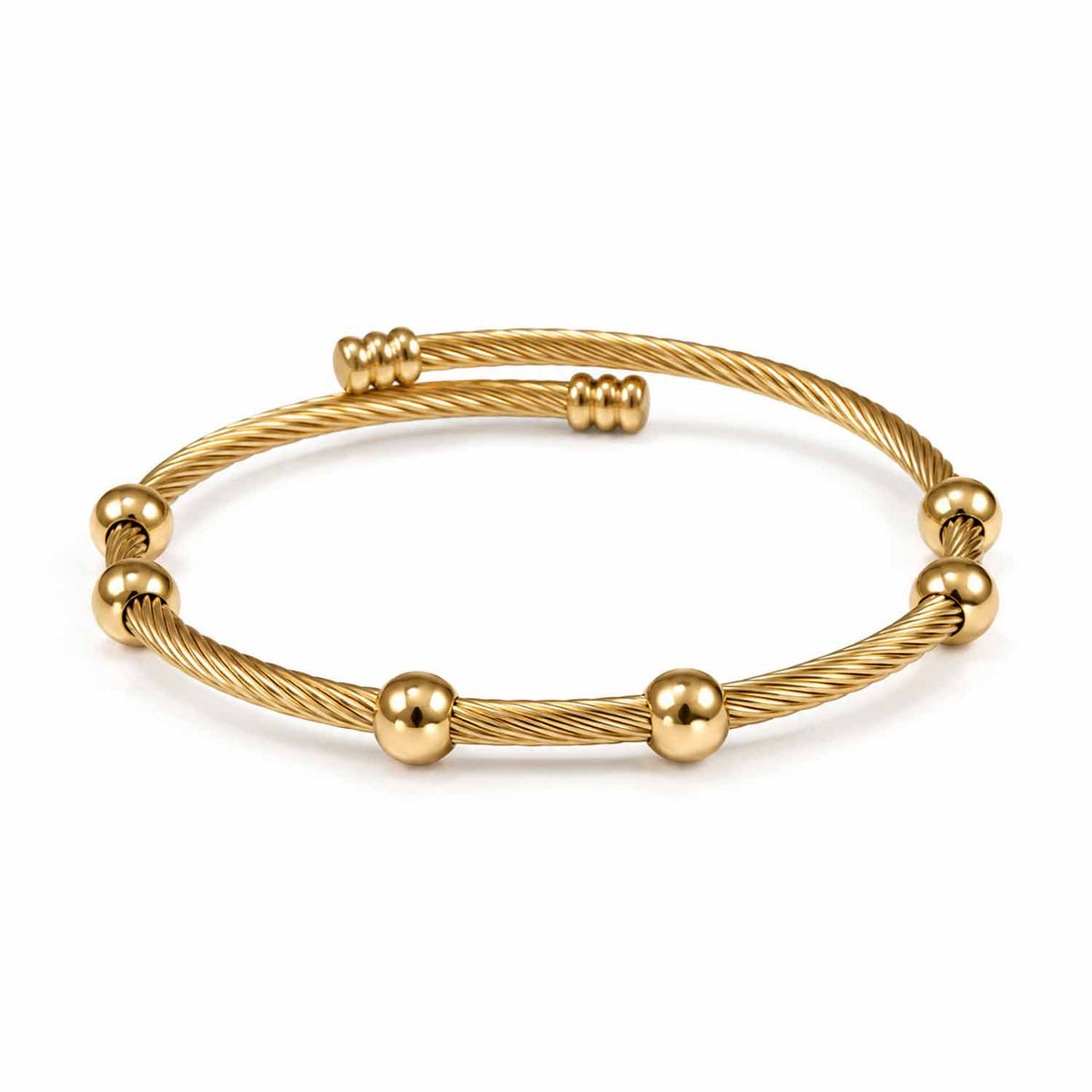 Gold twisted cable cuff bangle featuring a textured rope design and polished round bead detailing.