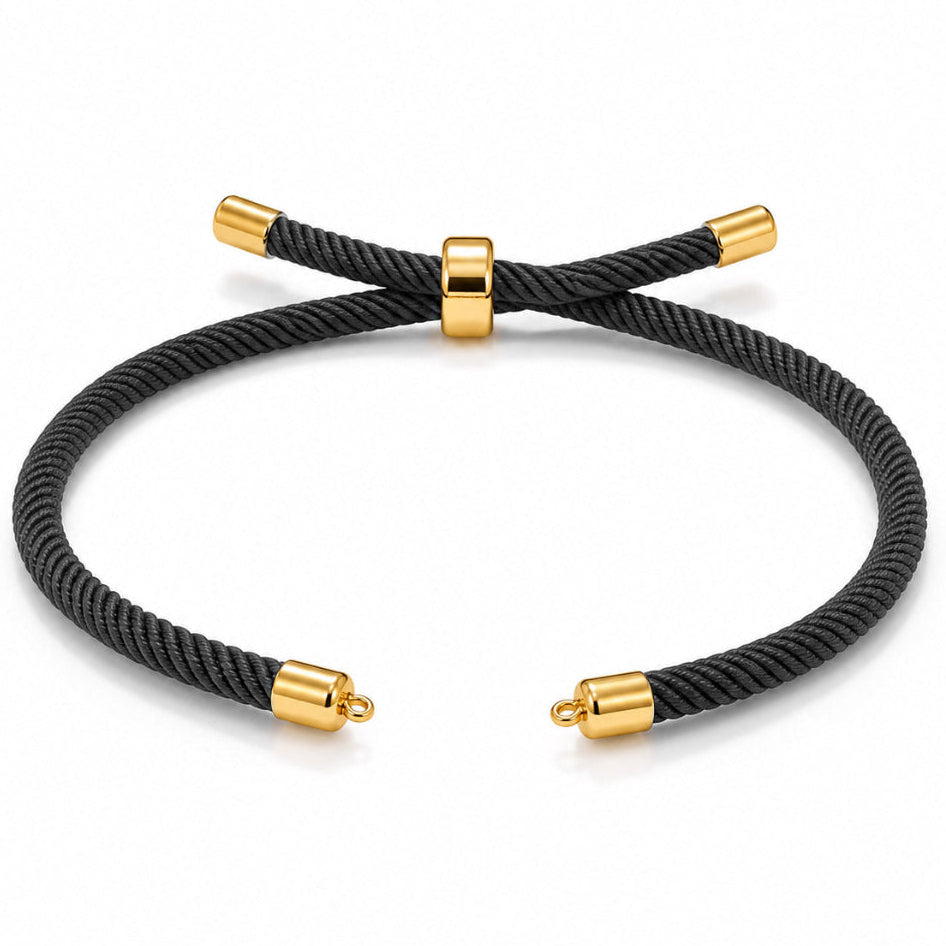 Black braided cord bracelet with gold-tone end caps and an adjustable sliding clasp, displayed on a clean white background.