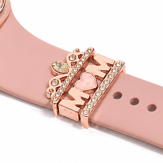 Rose gold smartwatch strap close-up featuring sparkling crystal bars and decorative charms with a heart and lightning bolt design.
