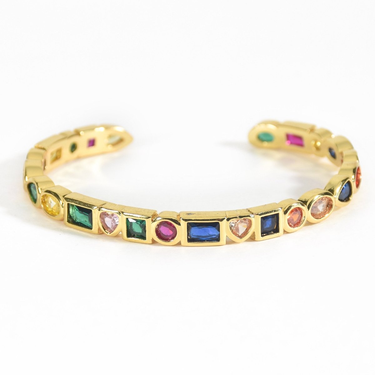 Stylish multi-colored cuff bangle with heart, pearl, and geometric charm detailing and an adjustable anti-tarnish finish, perfect for playful stacking, everyday glam, and trendy statement styling.