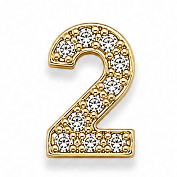Zoomed-out view of a gold-toned letter “2” charm decorated with sparkling white floral stones, placed on a clean white background.