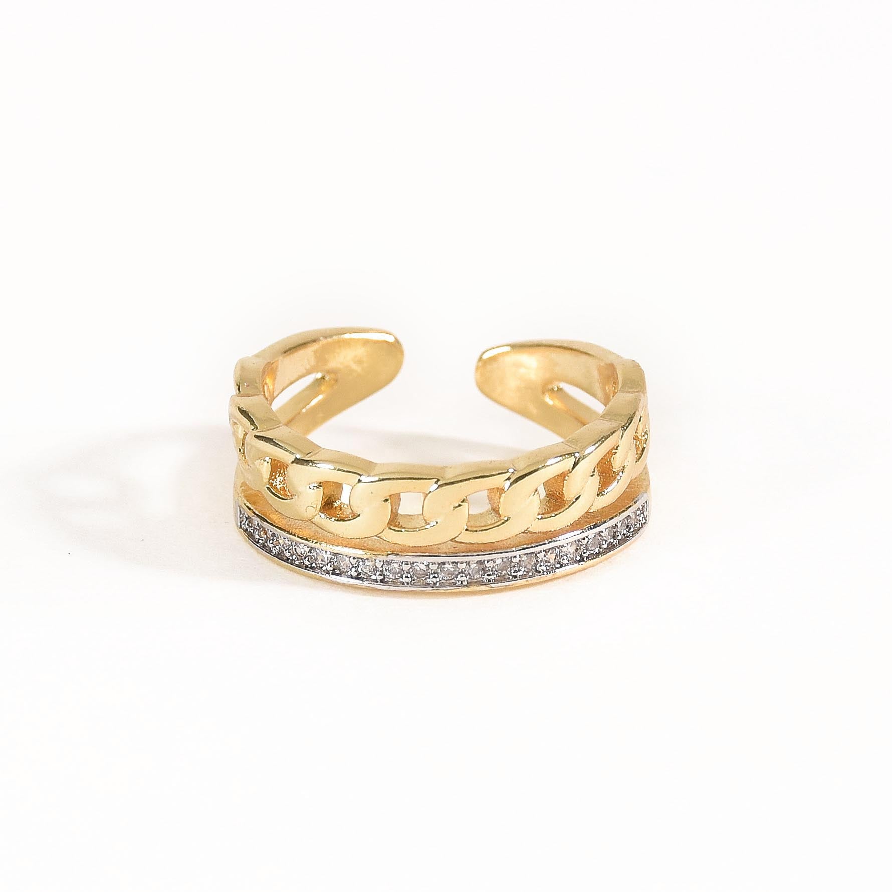 A three-piece gold ring stack featuring a criss-cross entwine band, a structured interlink design, and a bold fluid spiral statement ring.