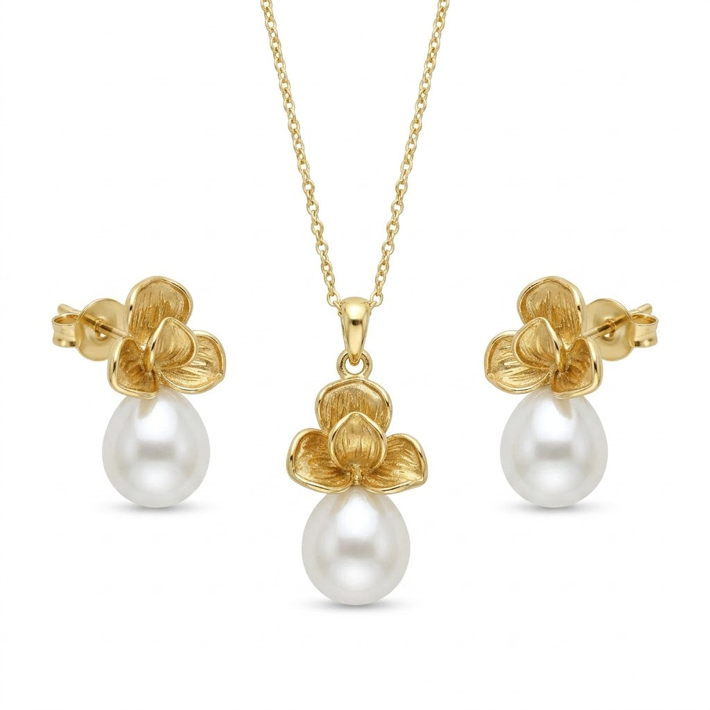 Gold floral pearl drop necklace set with matching stud earrings.
Elegant design on a clean white background.