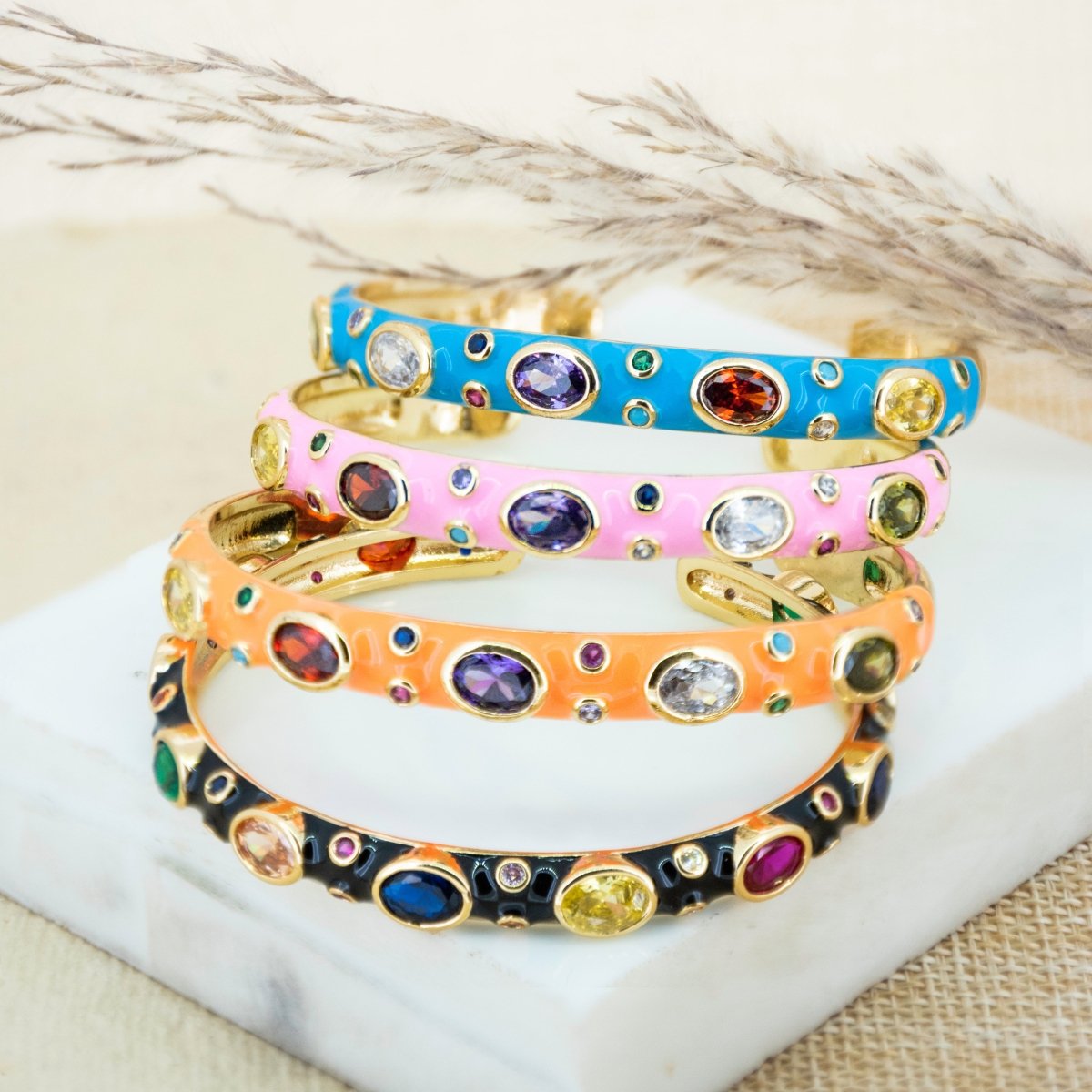 Elegant rainbow cuff bangles in soft pastel shades with an adjustable anti-tarnish finish, perfect for everyday wear, playful styling, and adding a colorful touch to any look.
