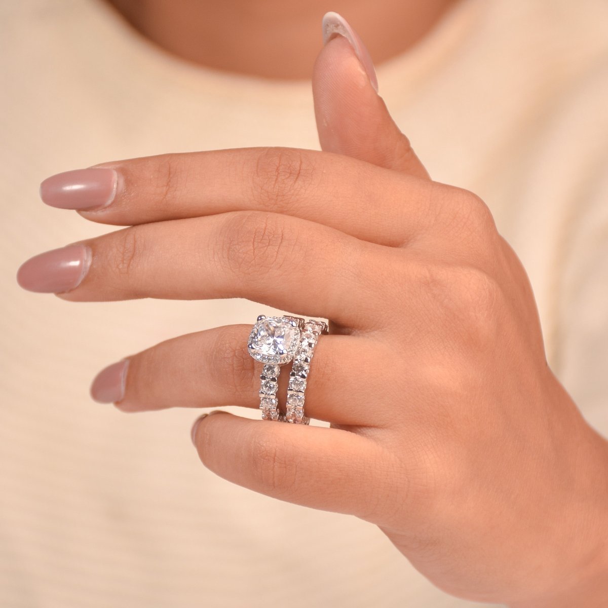 Elegant silver ring set featuring a cushion-cut center stone, sparkling halo, and diamond-studded eternity bands in anti-tarnish alloy. a luxurious statement piece perfect for gifting and special occasions.