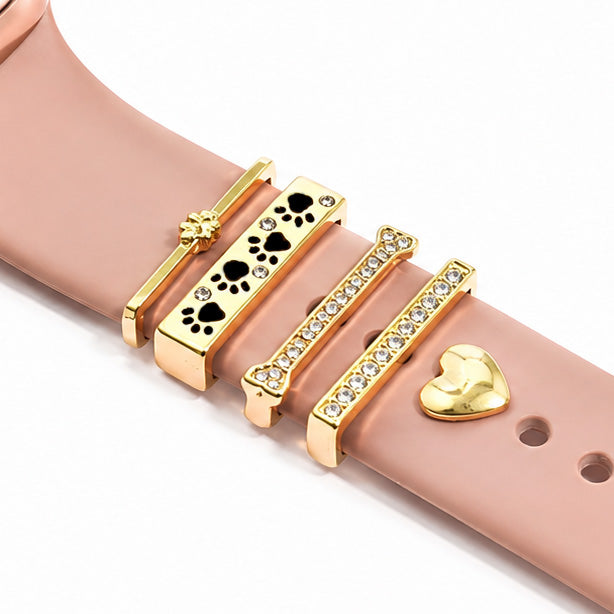 Rose gold watch strap decorated with gold charm beads, including floral, black playing-card suit, sparkling crystal, and heart designs.
