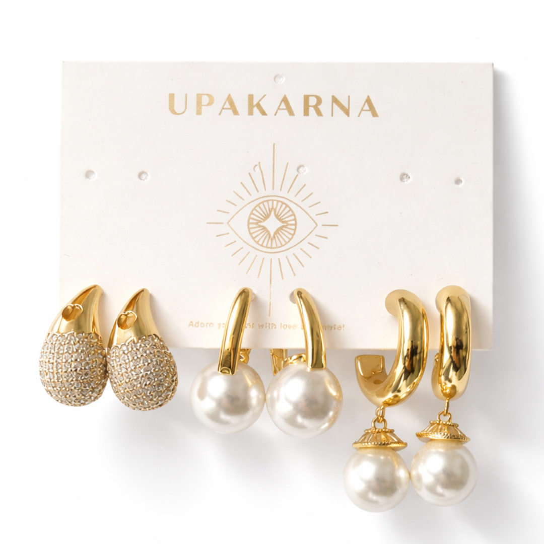 Elegant pearl earring trio featuring gold hoops, pearl studs, and shimmer tear drop earrings