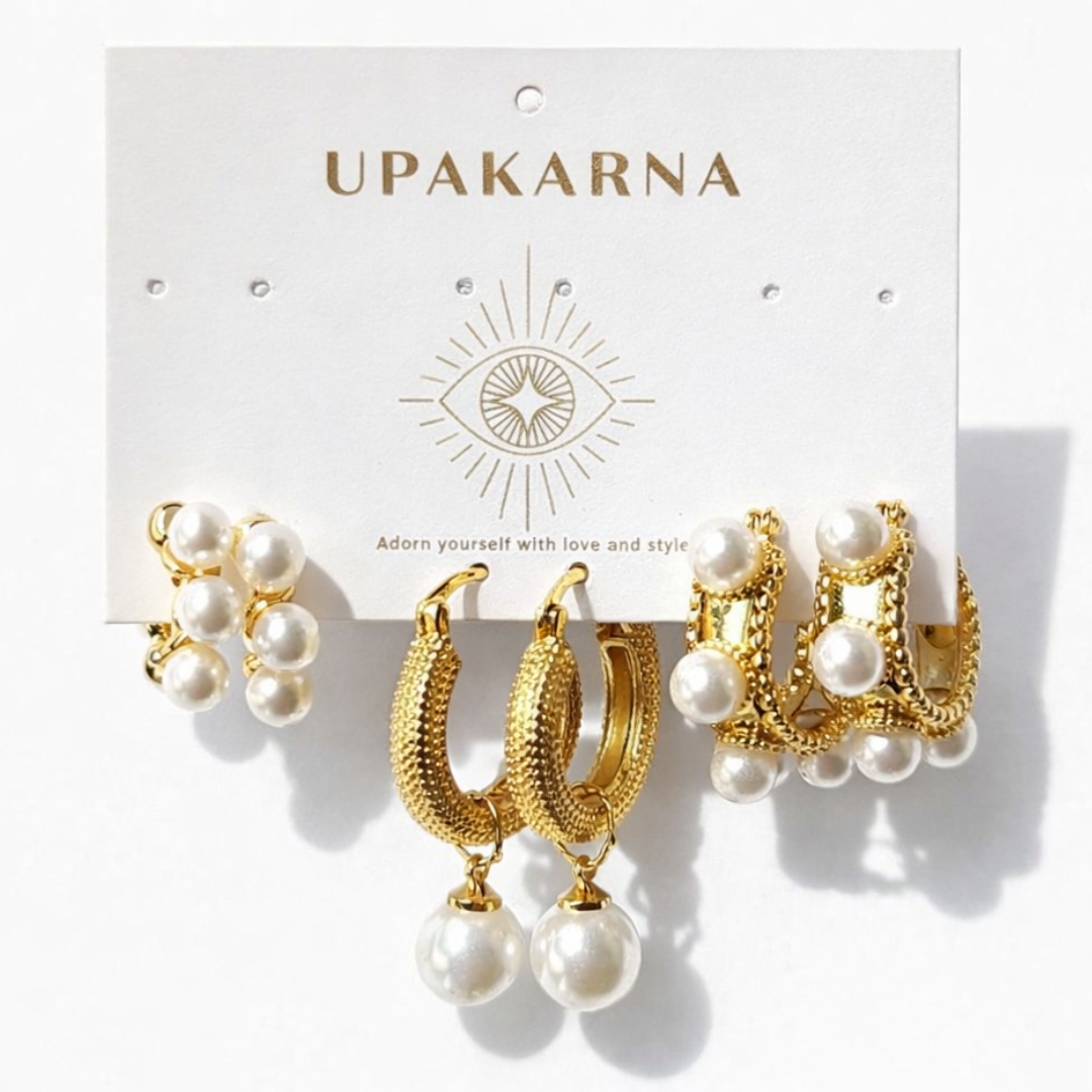 Pearlescent earring stack featuring gold hoops with pearl drops and clustered pearl hoop earrings