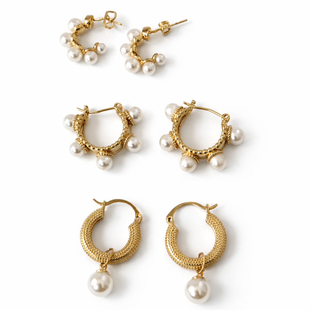 Pearlescent earring stack featuring gold hoops with pearl drops and clustered pearl hoop earrings