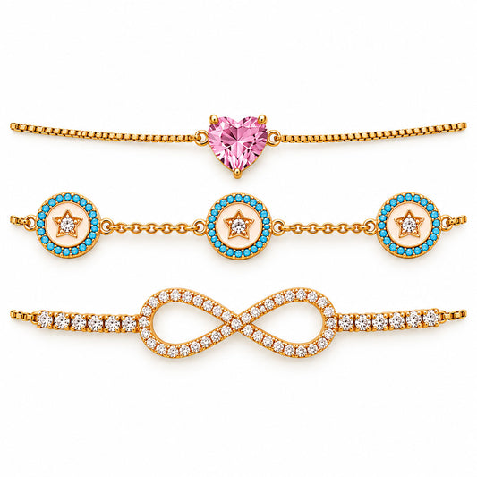 Three anti-tarnish gold-plated chain bracelets featuring a pink heart gemstone centerpiece, blue enamel star medallions with crystal accents, and a sparkling crystal infinity motif, arranged in parallel on a clean white background with a premium polished finish.