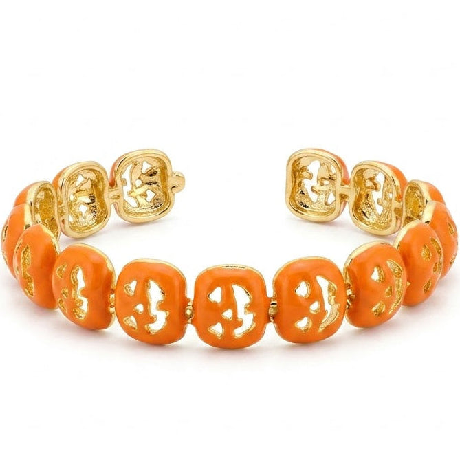 Anti-tarnish yellow gold open cuff bracelet featuring a repeating linked pattern coated in vibrant glossy orange enamel with abstract geometric openwork cutouts.