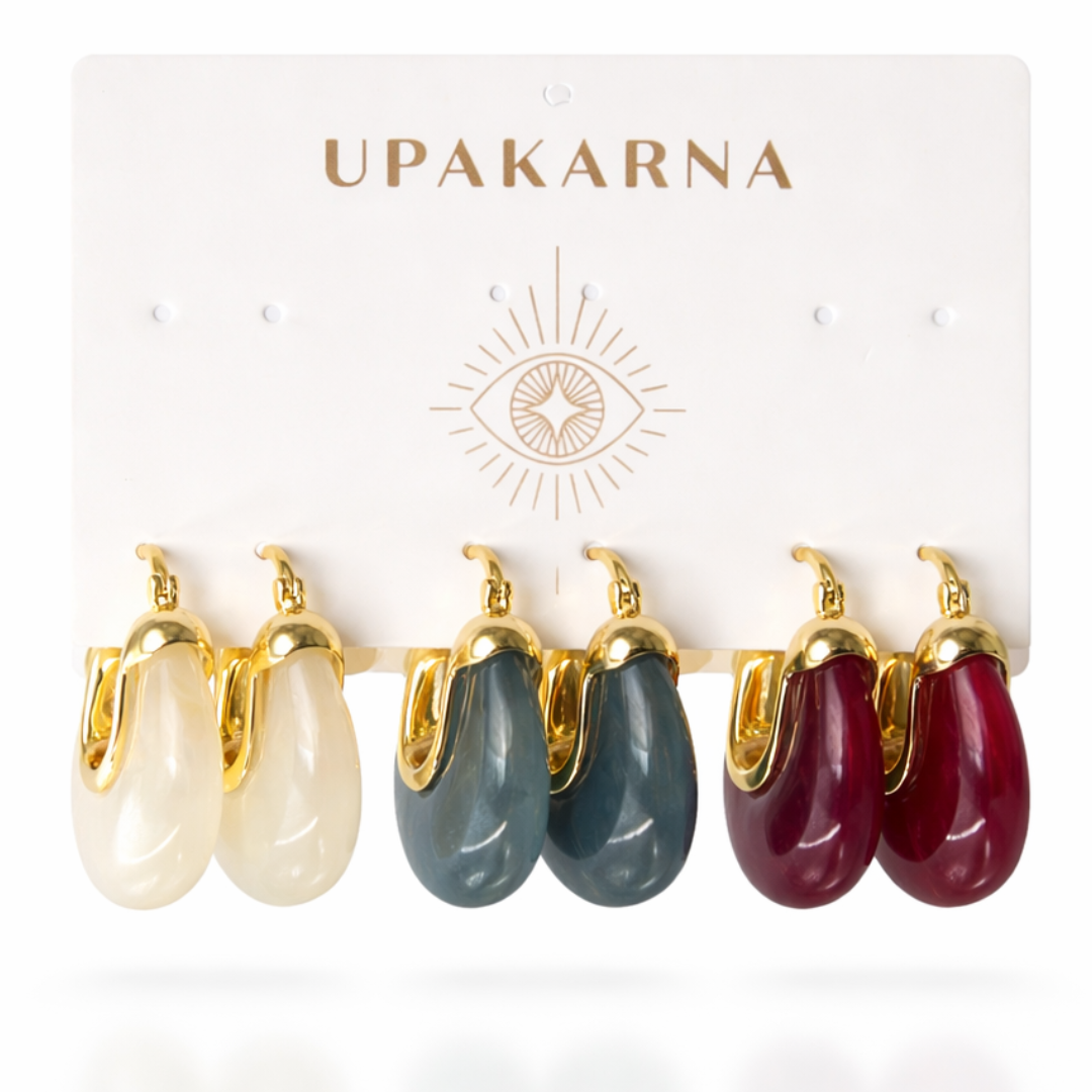 A three-pair earring stack featuring high-gloss resin "wee" hoops in deep sangria red, slate grey, and creamy white on a branded display card.