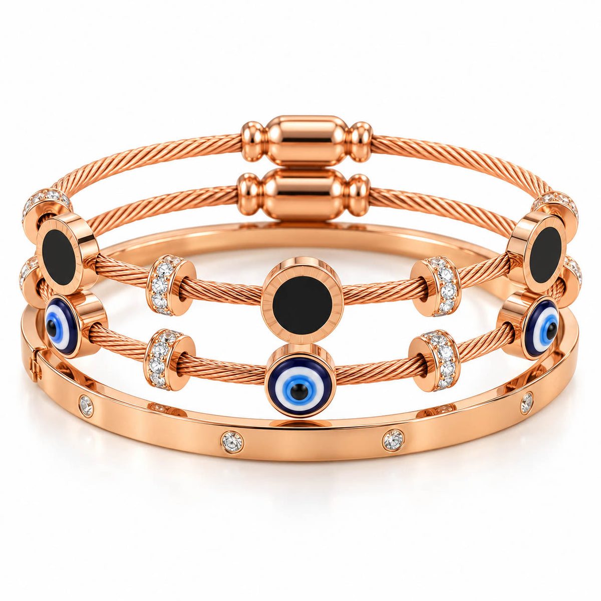 A studio shot of a curated luxury bracelet stack featuring multiple rose gold cable wire strands adorned with black circular enamel stations, blue-and-white evil eye charms, and sparkling rhinestone spacers, paired with a matching gem-set bangle.