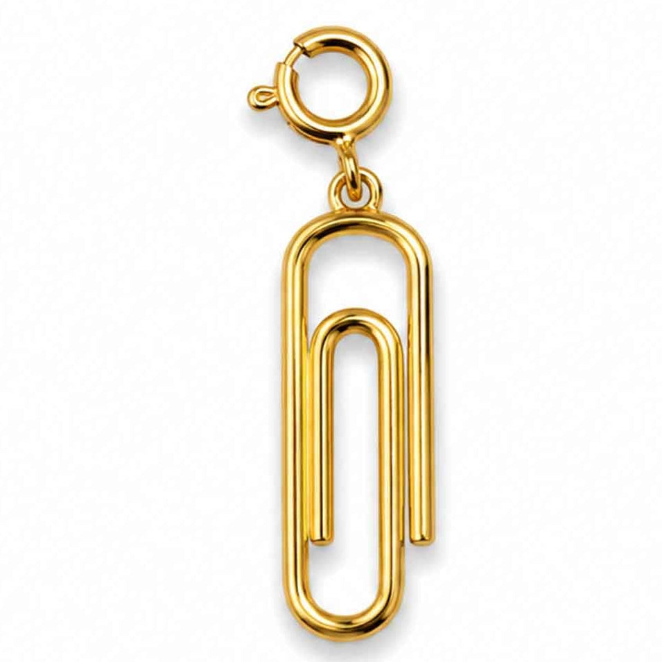 Zoomed-out view of a minimalist gold-tone paperclip-shaped charm, displayed on a clean white background.